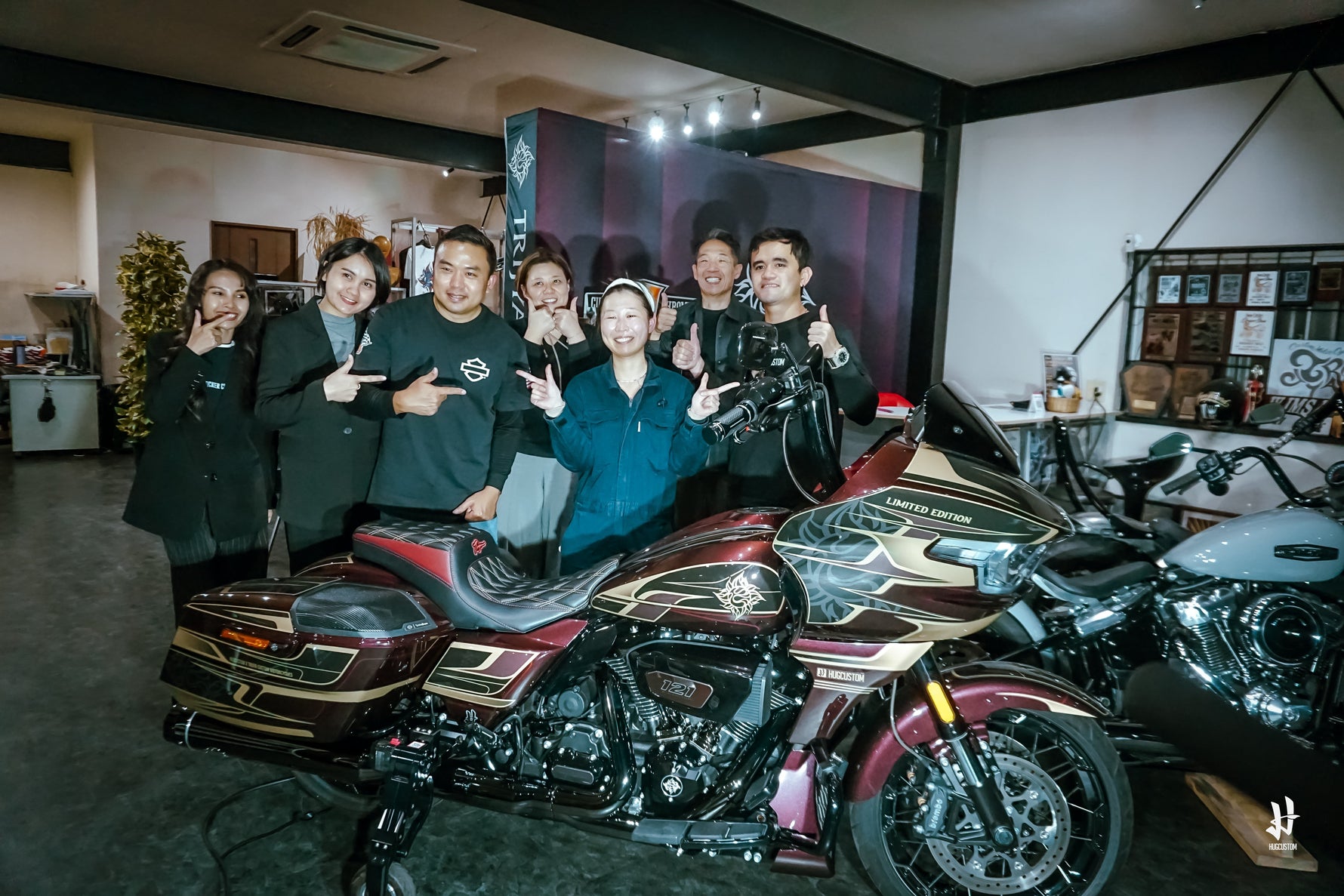 Group photo of Trija and HUGCUSTOM with custom harley-davidson