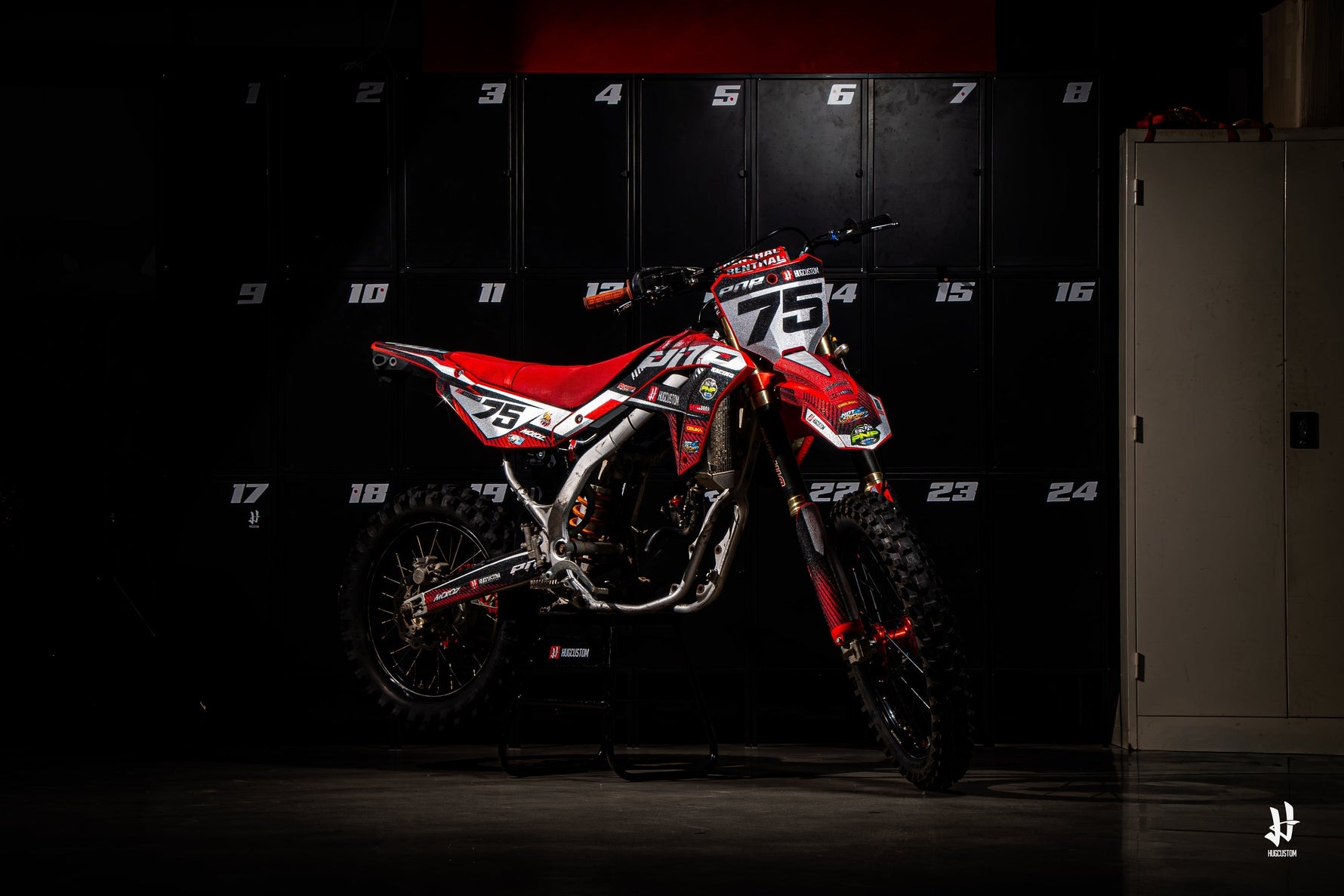 Red Motocross decals by HUGCUSTOM in front of black lockers