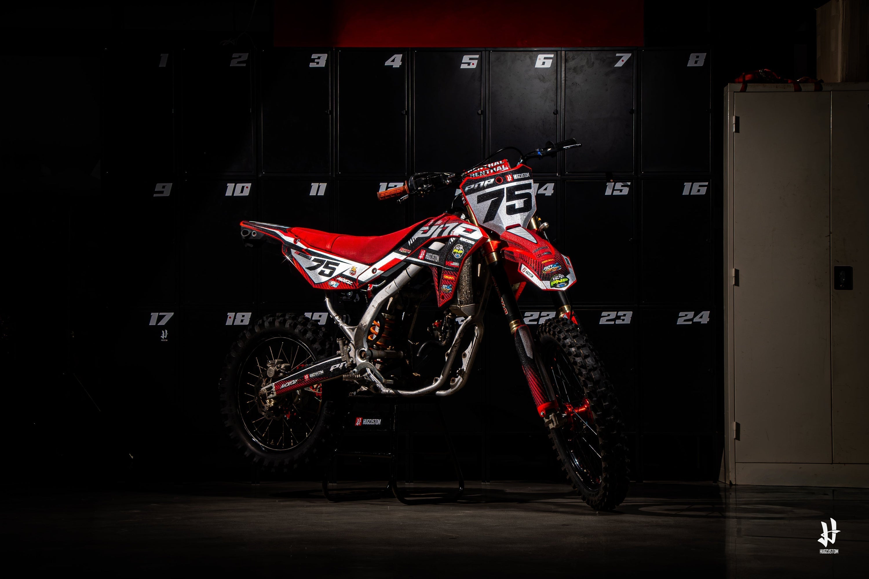 Red Motocross decals by HUGCUSTOM in front of black lockers